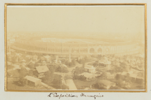 Altes Schwarz-Weiß-Foto eines Stadions umgeben von Gebäuden, Bäumen und Strommästen mit Text unten.