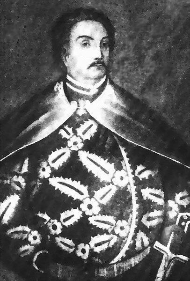 Schwarzes und weißes Foto von Papst Johannes Paul II. in Priesterkleidung, der eine schwarze Robe mit weißem Kragen und Manschetten trägt, die Hände gefaltet, strenger Gesichtsausdruck und direkter Blick.