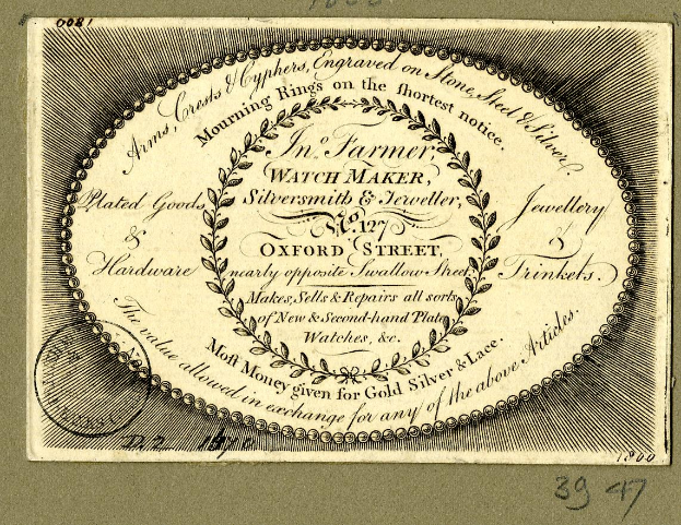 Alte Visitenkarte mit kreisförmigem Design und verblasster Schrift.